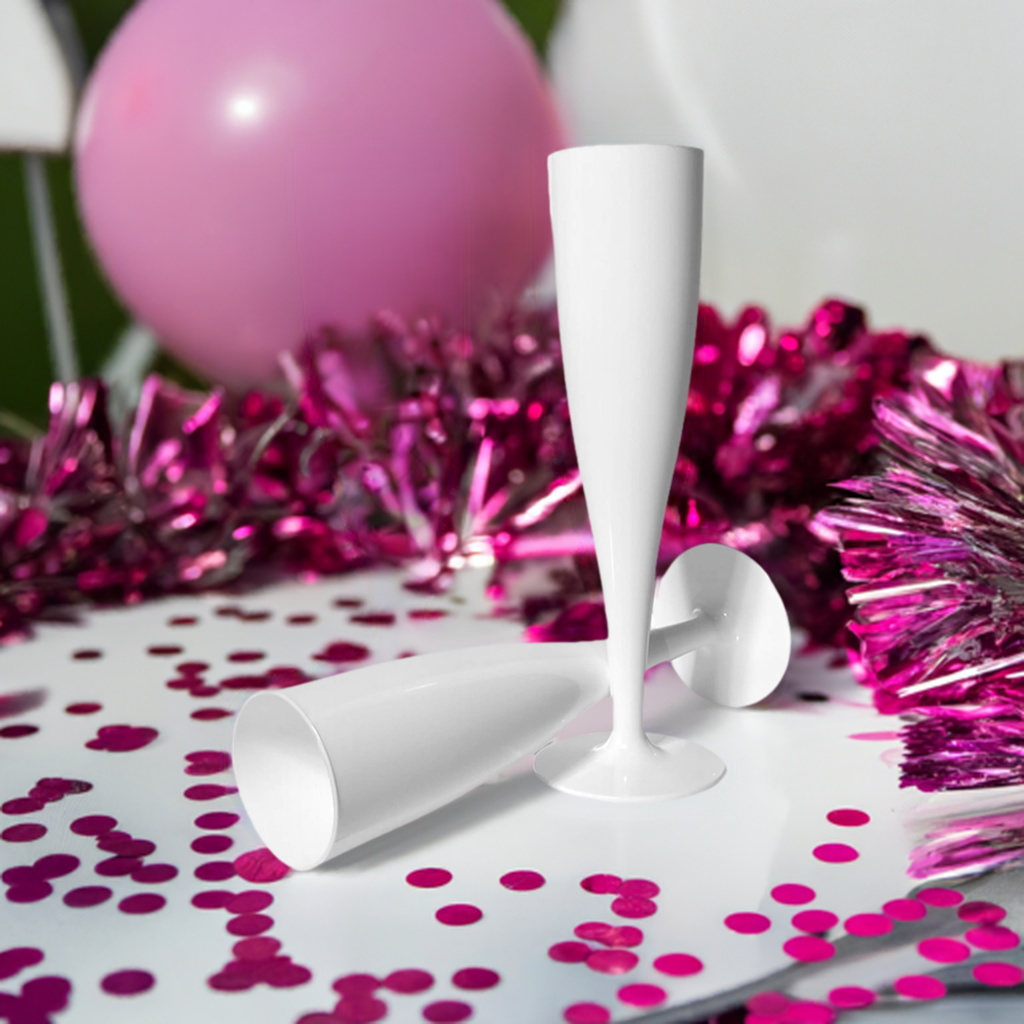 White Plastic Prosecco Champagne Flute Flutes on a white table surrounded by pink hen party decorations