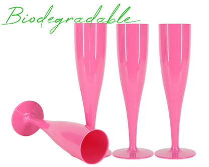 Four pink champagne flutes on a white background with the word biodegradable above them